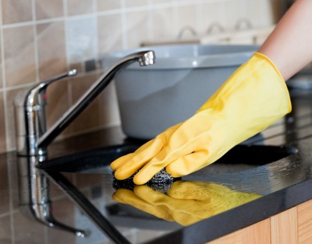 Professional Airbnb cleaner preparing a guest-ready bedroom
